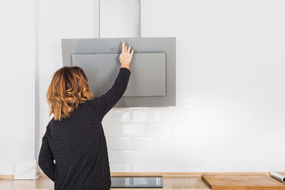 Woman cooker hood power turning on