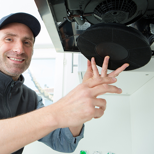 Man replacing a carbon filter in a cooker hood