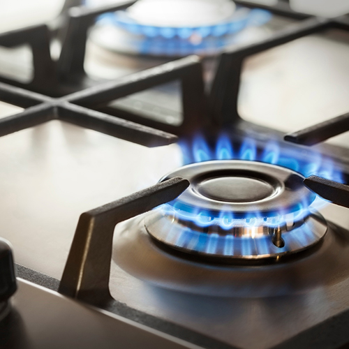 Stainless steel gas hob with burners lit