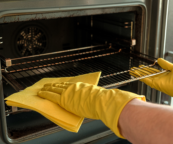 Man Cleaning Oven