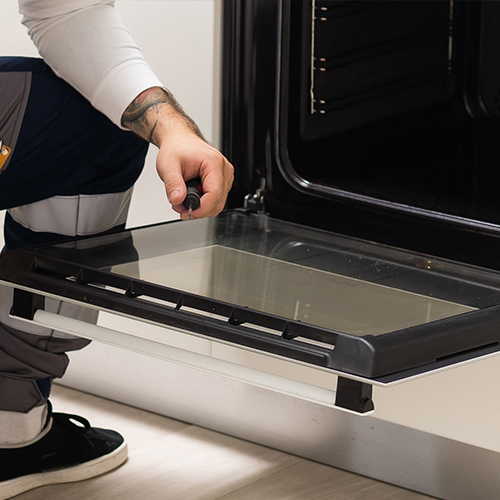 man installing an integrated oven