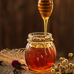 Honey dripping into pot