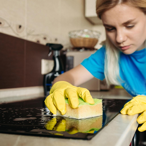 Woman Cleaning an Induction Hob